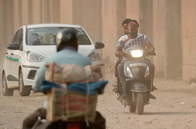 a man with his face covered with a scarf rides his scooter through a dusty neighbourhood on a smoggy day in delhi india november 15 2017 photo reuters a man with his face covered with a scarf rides his scooter through a dusty neighbourhood on a smoggy day in delhi india november 15 2017 photo reuters