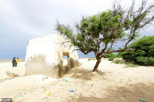 this file photo taken on october 26 2015 near saint louis du senegal shows the remains of a house of the doune baba dieye village which was abandoned because of the approaching sea photo afp