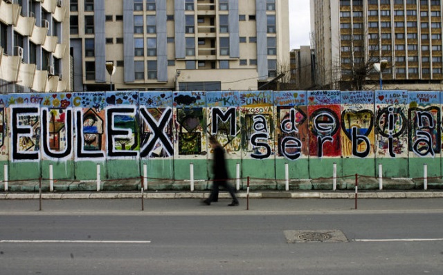 kosovo albanians walks by a grafiti reading quot eulex made in serbia quot in the kosovar capital of pristina on december 8 2008 the eu agreed in february 2008 to send the 2 000 strong eulex mission to kosovo to gradually replace a united nations operation and oversee the police judiciary and customs the un security council last week gave a green light to the planned eu mission which is likely to start its operation in kosovo on december 9 2008 under the un umbrella photo afp