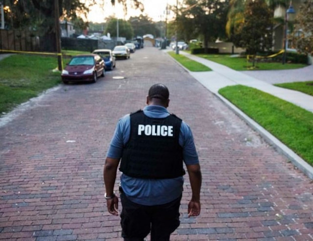 a police officer walks toward a crime scene in florida photo courtesy ap a police officer walks toward a crime scene in florida photo courtesy ap