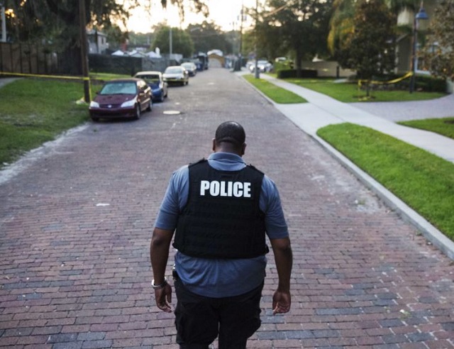 a police officer walks toward a crime scene in florida photo courtesy ap