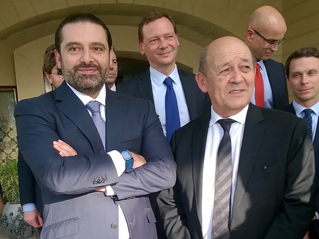 a picture taken on november 16 2017 shows french foreign minister jean yves le drian r posing for a photo with lebanese prime minister saad hariri in the saudi capital riyadh photo afp