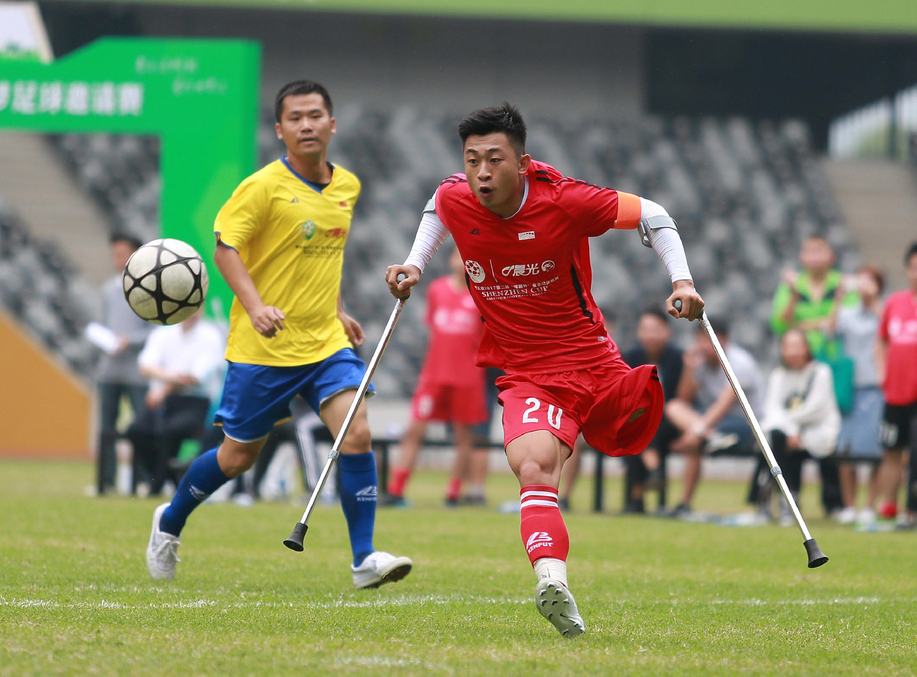 chinese footballer he yiyi has defied all odds to continue playing the sport he loves photo afp