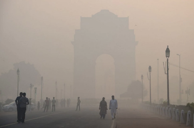 pedestrians walk near the india gate monument amid heavy smog in new delhi photo afp file