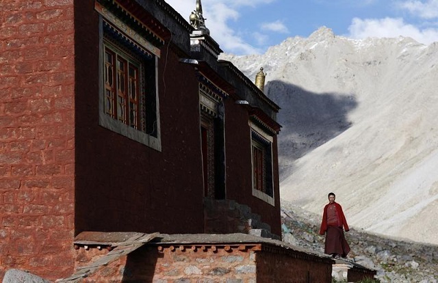 file photo a tibetan monk stands outside a temple near mount kailash in ngari tibet autonomous region september 3 2011 photo reuters