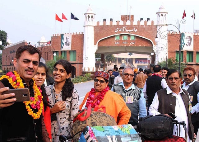 hindu pilgrims express joy on arriving in lahore through wagah crossing on foot photo app file hindu pilgrims express joy on arriving in lahore through wagah crossing on foot photo app file