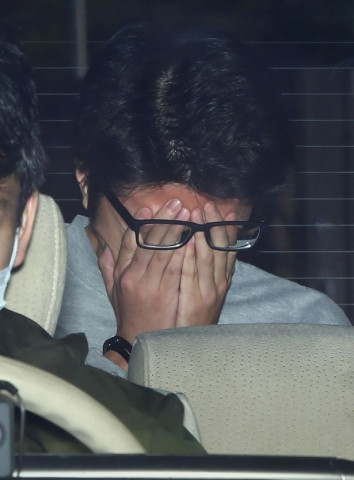 takahiro sheraishi covers his face as he transported to the prosecutor 039 s office from a police station photo afp takahiro sheraishi covers his face as he transported to the prosecutor 039 s office from a police station photo afp