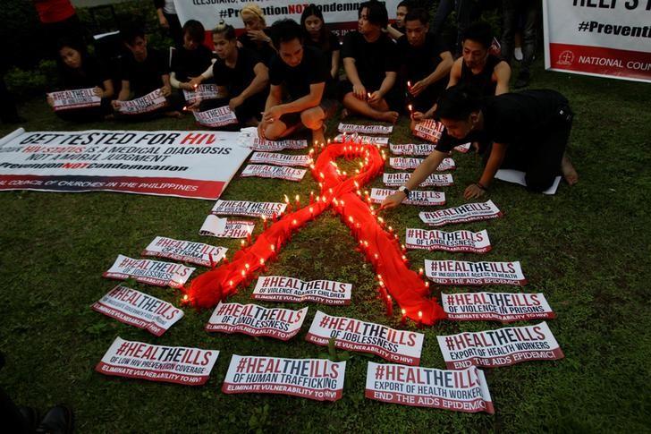 people light candles to mark world aids day in quezon city metro manila philippines photo reuters