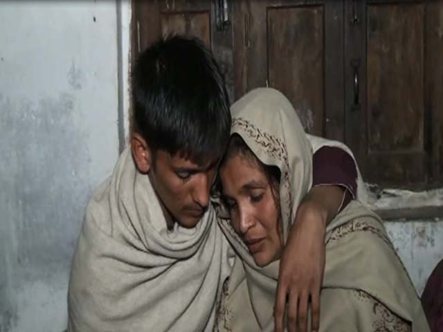 haider ali with his mother after reaching home in sambrial sialkot photo express