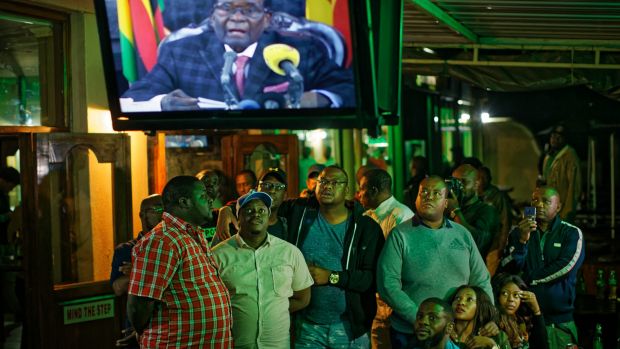 zimbabweans watch a televised address to the nation by president robert mugabe at a bar in downtown harare zimbabwe photo afp