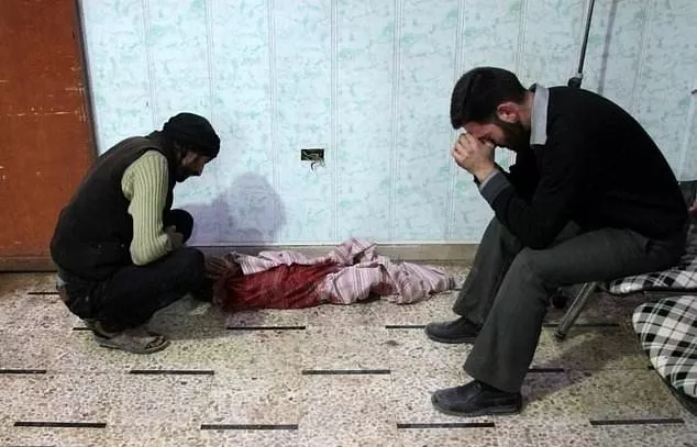 syrian men mourn a child in a makeshift clinic following shelling of the rebel held town of douma photo afp syrian men mourn a child in a makeshift clinic following shelling of the rebel held town of douma photo afp