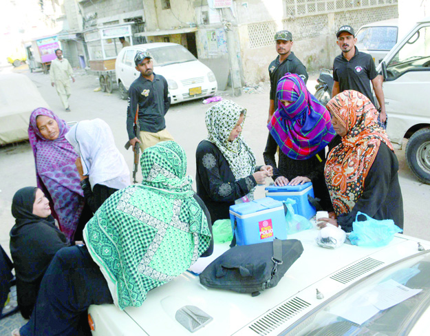 fighting a virus a team of volunteers prepares to administer polio drops to children under five years of age in khudad colony on the first day of the campaign photo rashid ajmeri express