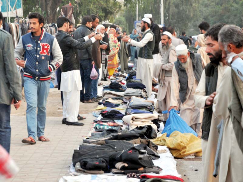 people buying warm clothes at aabpara market photo zafar aslam express