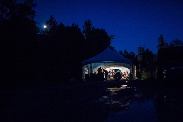 this file photo taken on august 05 2017 shows refugees who crossed the canada us border illegally near hemmingford quebec as they are processed in a tent after being arrested by the rcmp photo afp