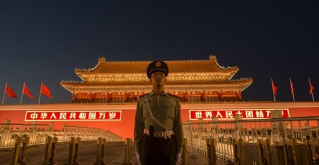 a chinese paramilitary police officer secures the front gate of the forbidden city in beijing which will exchange art works with the vatican starting in march photo afp