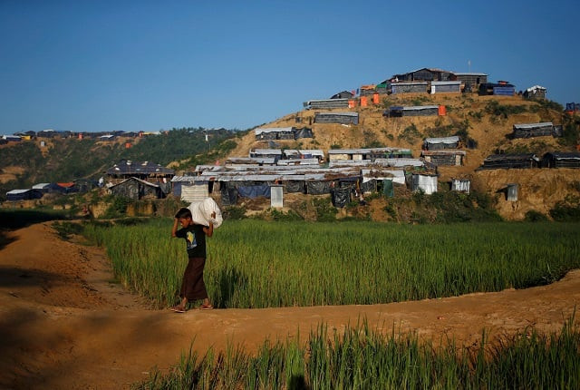 a rohingya refugee boy carrying a sack filled with goods walks at the palong khali refugee camp near cox 039 s bazar bangladesh november 7 2017 photo reuters