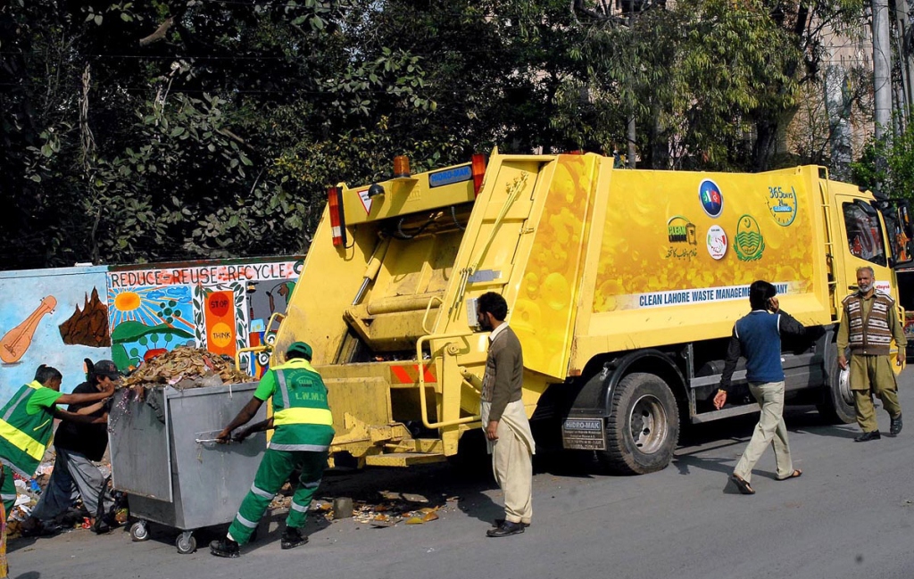 workers of lahore waste management company busy in removing the garbage as punjab government launched modern and organized system of cleanliness in the provincial capital city with the collaboration of turk companies photo app