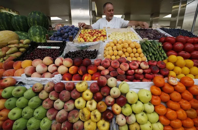 a vendor sells vegetables and fruits at the city market photo reuters a vendor sells vegetables and fruits at the city market photo reuters