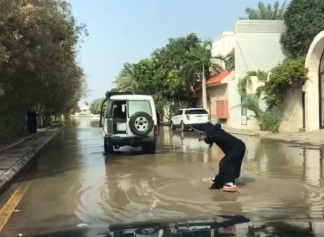 Saudi woman attempts ‘street surfing’ in Jeddah floodwater