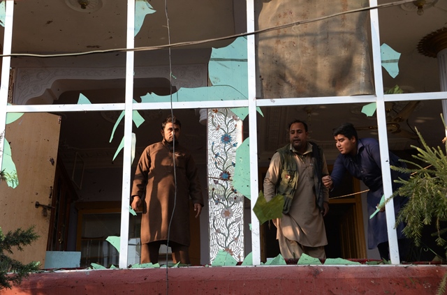 afghan residents inspect damages on a building near the site of suicide attack in jalalabad on november 23 2017 photo afp