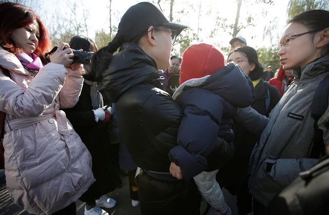 a parent is surrounded by members of the media outside the kindergarten run by pre school operator ryb education inc being investigated by china 039 s police in beijing china november 24 2017 photo reuters