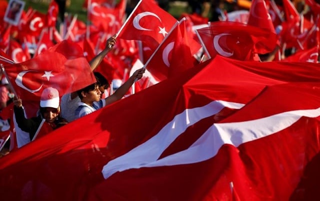 file photo people wave turkey 039 s national flags as they attend a ceremony marking the first anniversary of the attempted coup at the bosphorus bridge in istanbul turkey july 15 2017 photo reuters