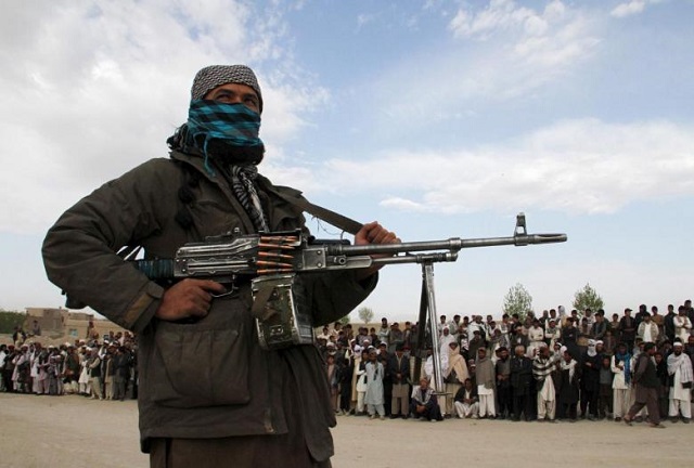 file photo a member of the taliban insurgent and other people stand at the site during the execution of three men in ghazni province april 18 2015 photo reuters