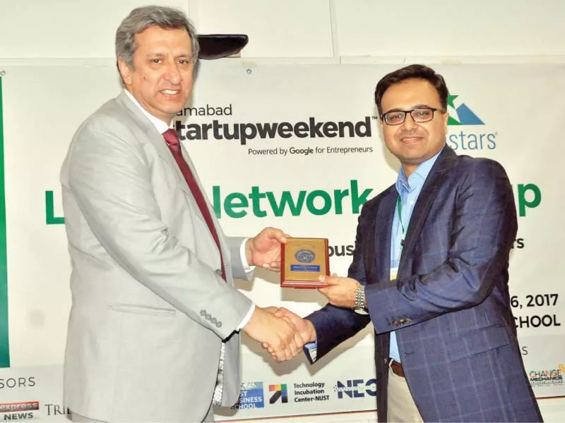 nbs dean dr nokhaiz sarwar presents a shield to sybrid ceo ather imran photo zafar aslam express nbs dean dr nokhaiz sarwar presents a shield to sybrid ceo ather imran photo zafar aslam express