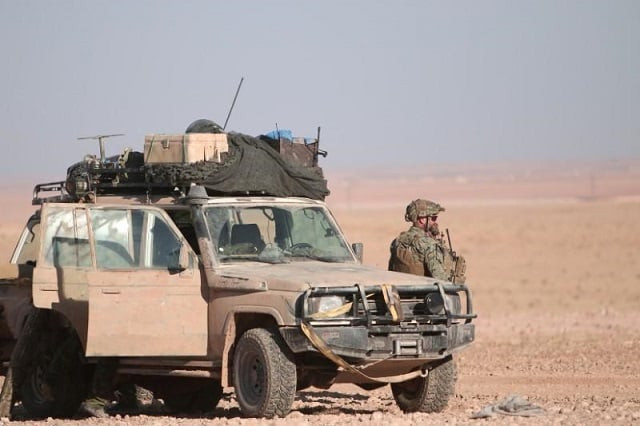 a us fighter stands near a military vehicle north of raqqa city syria november 6 2016 photo reuters a us fighter stands near a military vehicle north of raqqa city syria november 6 2016 photo reuters