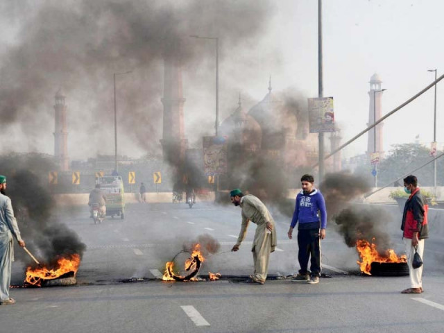 activists of religious parties set tyres on fire on azadi interchange during the protest photo online activists of religious parties set tyres on fire on azadi interchange during the protest photo online