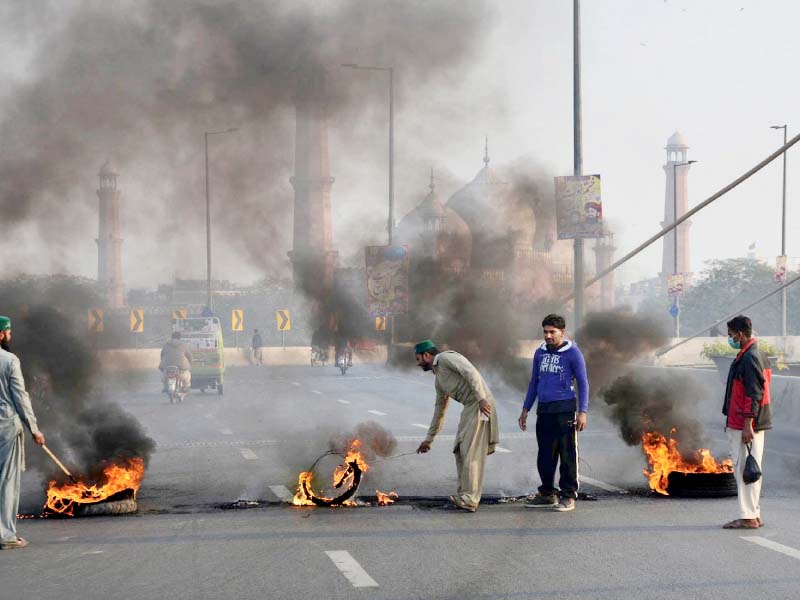 activists of religious parties set tyres on fire on azadi interchange during the protest photo online