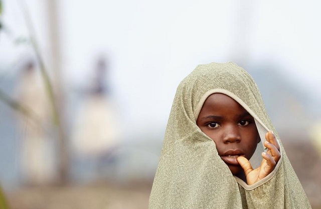 file photo a congolese refugee girl displaced by fighting between the congo army and a rebel group covers herself with a sheet at bukanga transit camp in bundibugyo town camp kampala july 17 2013 photo reuters