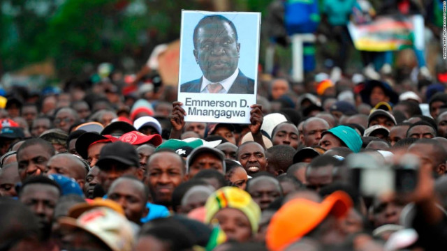 people hold a portrait of zimbabwe former deputy president during a demonstration demanding the resignation of zimbabwe 039 s president on november 18 2017 in harare photo afp