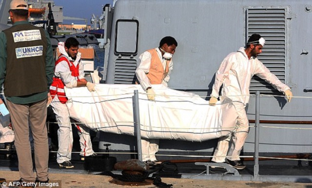 libyan coastguards carry the body of an african migrant at a naval base in the capital tripoli photo afp