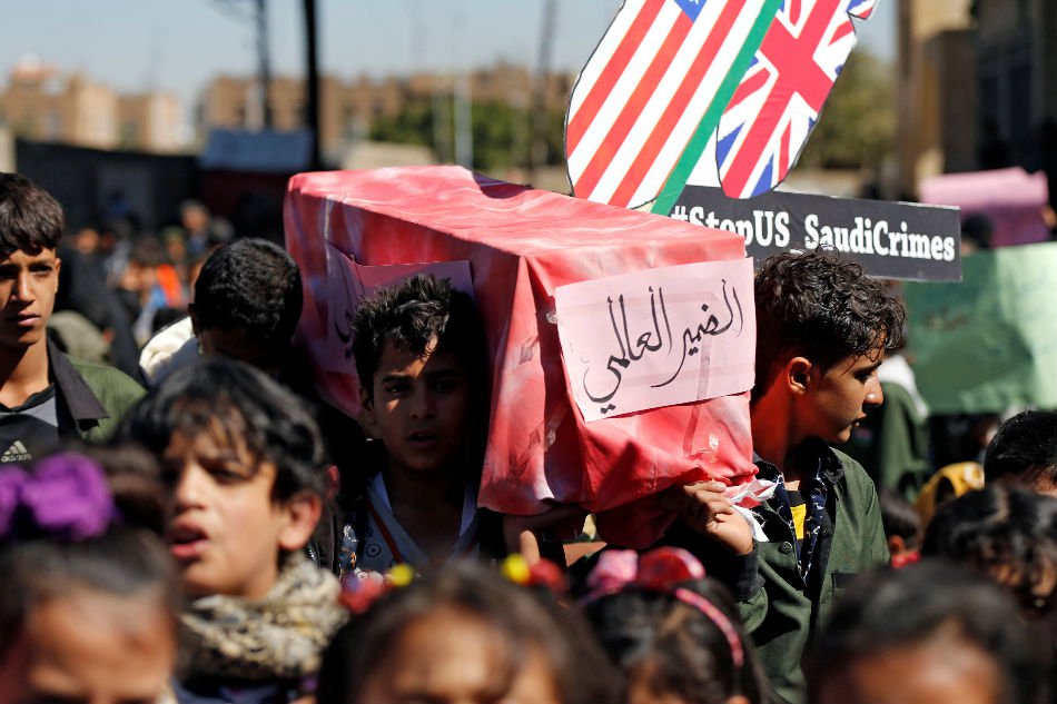 children carry a mock coffin during a protest against the saudi led coalition outside the un offices in sanaa yemen photo reuters