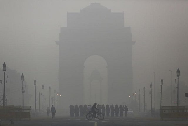 file photo a man rides his bicycle next to indian soldiers marching in front of india gate on a smoggy morning in new delhi india december 1 2015 photo reuters