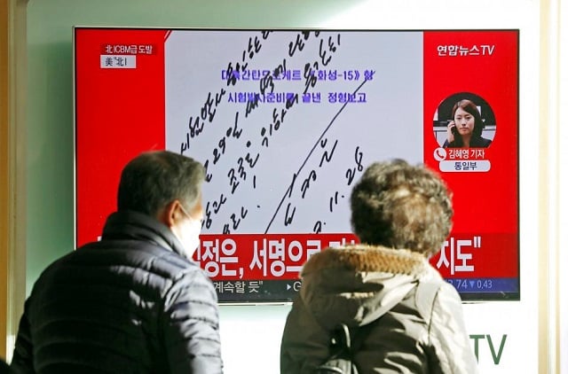 people watch a tv broadcasting a news report on north korea firing what appeared to be an intercontinental ballistic missile icbm that landed close to japan in seoul south korea november 29 2017 in this handwritten order visible on a screen dated november 28 by kim jong un he says quot i order a test launch carry out on nov 29 at dawn fire it bravely for the party and the motherland quot photo reuters