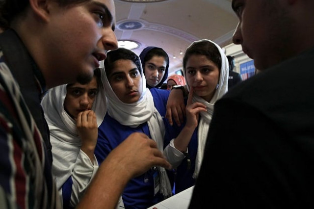 somayeh faruqi lida azizi yasimin yasinzadah and kawsar roshan of team afghanistan listen through embassy staff mojib ghaznawi s l translation as they discuss strategy with a member of team north america photo afp somayeh faruqi lida azizi yasimin yasinzadah and kawsar roshan of team afghanistan listen through embassy staff mojib ghaznawi s l translation as they discuss strategy with a member of team north america photo afp
