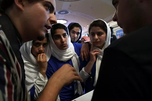 somayeh faruqi lida azizi yasimin yasinzadah and kawsar roshan of team afghanistan listen through embassy staff mojib ghaznawi s l translation as they discuss strategy with a member of team north america photo afp somayeh faruqi lida azizi yasimin yasinzadah and kawsar roshan of team afghanistan listen through embassy staff mojib ghaznawi s l translation as they discuss strategy with a member of team north america photo afp