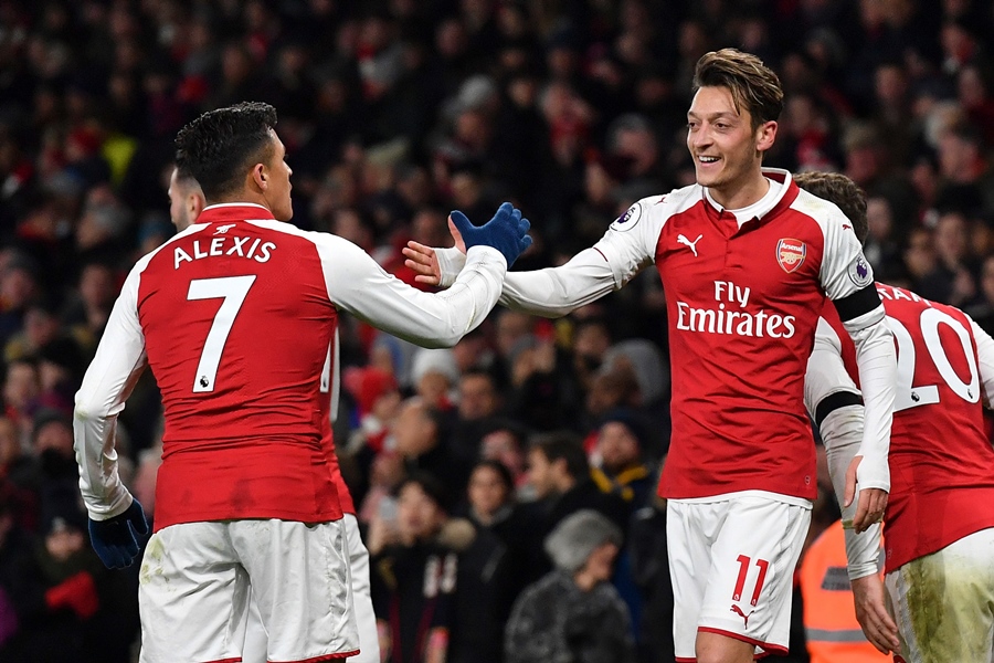 arsenal 039 s german midfielder mesut ozil r celebrates scoring their fourth goal during the english premier league football match between arsenal and huddersfield town at the emirates stadium in london on november 29 2017 photo afp