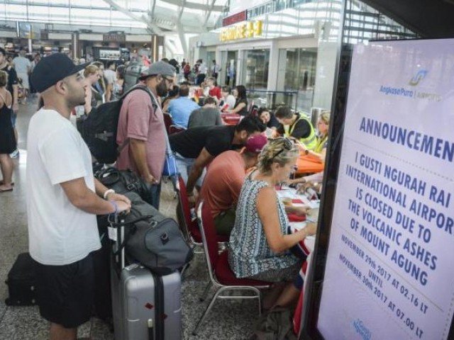 tourists wait at ngurah rai international airport in denpasar bali photo afp