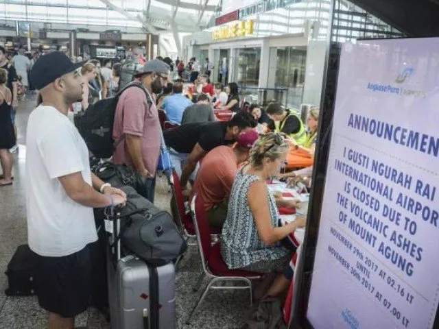 tourists wait at ngurah rai international airport in denpasar bali photo afp tourists wait at ngurah rai international airport in denpasar bali photo afp