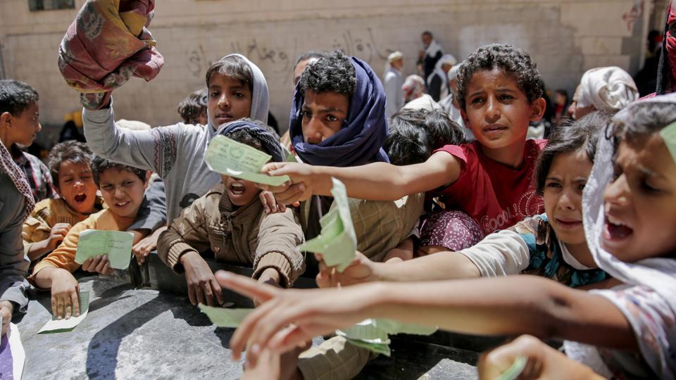 yemenis present documents in order to receive food rations provided by a local charity in sanaa photo afp