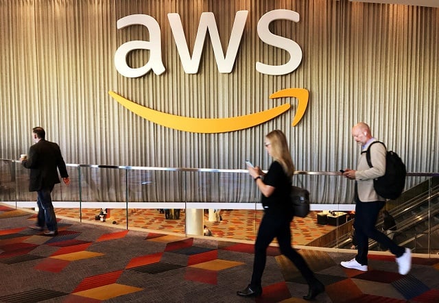 attendees at amazon com inc annual cloud computing conference walk past the amazon web services logo in las vegas nevada us november 30 2017 photo reuters