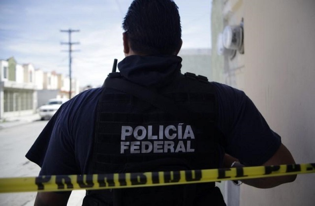 file photo   a federal police officer stands behind a police tape near a crime scene in apodaca on the outskirts of monterrey february 26 2012 photo reuters