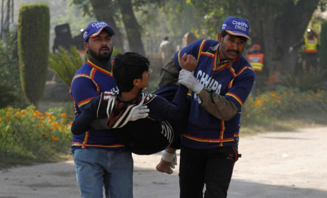 rescue workers assist an injured student from the shooting at directorate of agriculture institute in peshawar photo reuters
