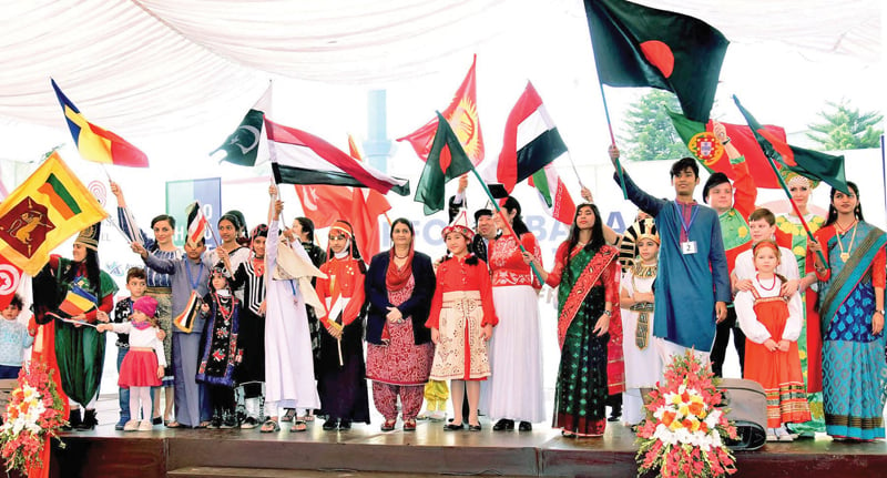 begum mamnoon hussein with children of various countries during the pfowa charity bazaar photo app