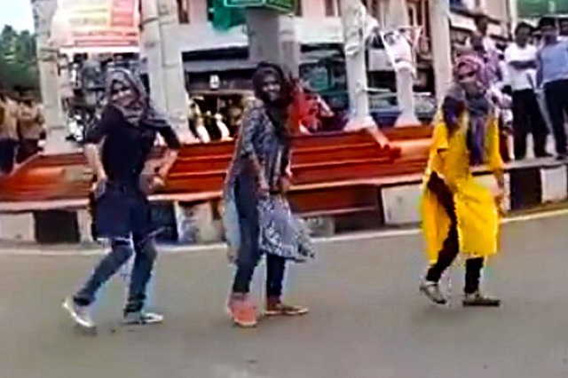 screen grab of the video showing three women dancing while wearing a hijab