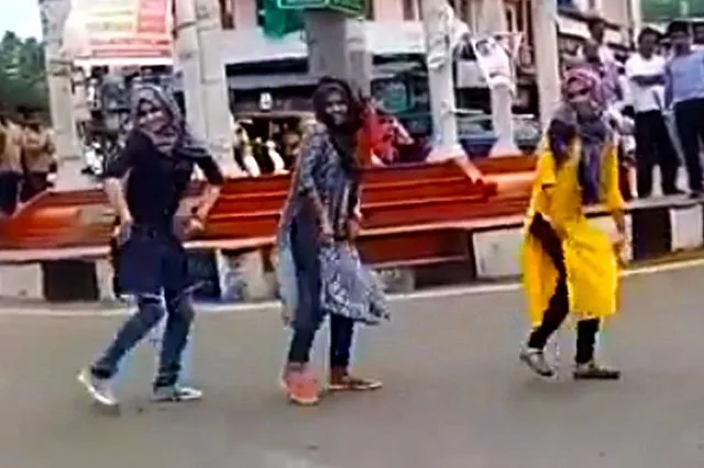 screen grab of the video showing three women dancing while wearing a hijab screen grab of the video showing three women dancing while wearing a hijab