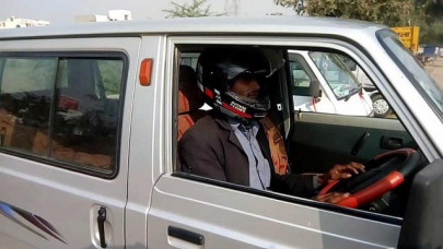 indian traffic warden fines man for not wearing helmet while driving car indian traffic warden fines man for not wearing helmet while driving car